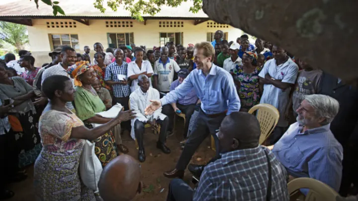 Daniel Speckhard, president and CEO of Lutheran World Relief and IMA World Health, greets local residents at a food distribution in Kananga, DRC.